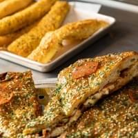 stuffed whole pizza and garlic breadsticks