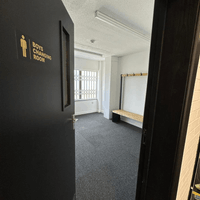 Dedicated boys changing room with seating and storage space for students.