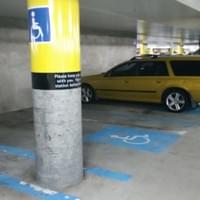 An accessible car parking space in an underground car parking level of a shopping centre An accessible car parking space in an underground car parking level of a shopping centre