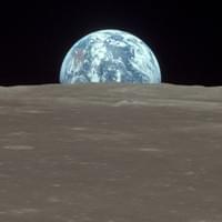 The view from the Apollo 11 Command and Service Module (CSM) "Columbia" shows the Earth rising above the Moon's horizon on July 20th, 1969. The lunar terrain pictured is in the area of Smyth's Sea on the nearside. (NASA) The view from the Apollo 11 Command and Service Module (CSM) "Columbia" shows the Earth rising above the Moon's horizon on July 20th, 1969. The lunar terrain pictured is in the area of Smyth's Sea on the nearside. (NASA)