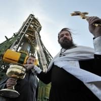 A Russian Orthodox priest blesses the Soyuz TMA-18 spacecraft at Baikonur Cosmodrome on April 1, 2010. (VYACHESLAV OSELEDKO/AFP/Getty Images) A Russian Orthodox priest blesses the Soyuz TMA-18 spacecraft at Baikonur Cosmodrome on April 1, 2010. (VYACHESLAV OSELEDKO/AFP/Getty Images)