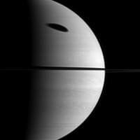 The shadow of Saturn's largest moon darkens a huge portion of the gas giant planet. Titan (5,150 km, or 3,200 mi across) is not pictured here, but its shadow is elongated across Saturn's upper atmosphere. The image was taken with the Cassini spacecraft wide-angle camera on November 7th, 2009 using a spectral filter sensitive to wavelengths of near-infrared light centered at 752 nanometers. The view was obtained at a distance of approximately 2.1 million km (1.3 million mi) from Saturn.