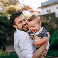 A dad holding a baby