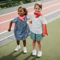 Two young kids wearing capes