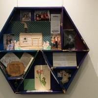Rebecca Gabrielle The cat’s in the cradle, but you’re so far away, 2021 Wood, acrylic paint, collected objects of Thomas McEniry including letters, a tablet with bullet hole, letters, urn, artwork by Thomas, and photographs 34 x 30 inches  This reliquary holds items collected and provided by Thomas McEniry’s mother, Carol Luke. Rebecca Gabrielle The cat’s in the cradle, but you’re so far away, 2021 Wood, acrylic paint, collected objects of Thomas McEniry including letters, a tablet with bullet hole, letters, urn, artwork by Thomas, and photographs 34 x 30 inches  This reliquary holds items collected and provided by Thomas McEniry’s mother, Carol Luke.