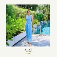 Young professional woman poses in front of an An Bang resort swimming pool (Hoi An), wearing new bespoke tailored suit.