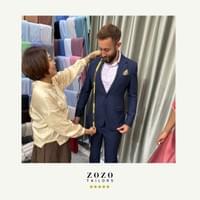 Young man wearing his new custom tailored suit in a cashmere fabric during the final fitting with his An Bang tailor.