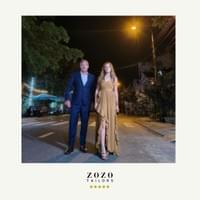 Father and teen daughter stand together wearing bespoke tailored suit and gown they commissioned in Hoi An.