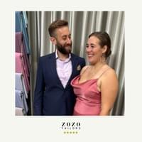 In their tailor's studio, couple ready for a social event. Silk-mix evening gown for her. Cashmere lounge suit for him..