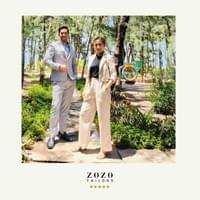 Young professional couple pose in the garden of their An Bang beach resort (Hoi An), wearing their new tailored suits.