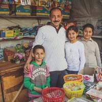 "I have been displaced three times, and what people just don’t get is that we are Syrians as everyone here, we’ve just been deprived of our lives. My wife and my daughters sleep at the mosque and I sleep under this tent against the mosque, I have to maintain my store. Before I had a company, employees, eight machines, we worked with stone. As I came to work in Aleppo, the “free army” as they used to be called before, deduced that I was pro-regime and they burned my house, stole my machines and they shot me in the leg. I lost everything and I can’t even afford a rent now. I set up this tent and I have this small stall to survive with my wife and four children…   It is so hard… You work your whole life to build something and suddenly overnight, you have nothing. I wanted to cling to life, I moved my family in another area of the city and I managed to rent a machine to keep working but they came back, they gained ground and we had to flee again, and again.  I had an open-heart surgery a few years ago, I’m in poor health but I still try to do my best, I cannot carry anything, collecting water is too hard because it’s impossible for me to carry the water container so it’s my wife and my son who take care of that; even if I don’t want my son to work I have no choice but to ask him to help me. I think about my daughters, I have three daughters and I believe I was less afraid when my house burnt than today to protect my daughters, I’m scared for them. My dream would be to find a new house, a place for us, and even if I thank God for this little job I have, I would like to find something else; I worked hard before with my company. My little boy will always be able to hold its own, but I’m scared for my daughters. I ensure that my four children study whatever happens to be, I’ll give my life if I have to."