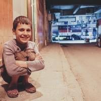 "I live here in Aleppo, before with my family, then in the street and now with this woman who keeps me Ashrafié with her. She never forced me to go to the streets and ask people for money, I ask money myself and I give it to her. In exchange I have a bed, a roof and some food. I sleep beside her or next to her mother because they want me to be like their child. It's difficult to survive in the street, people insult you, don't respect you. I give all my money to this woman because they have nothing, they're too poor and her husband died. Before she was living in a garden, a garden that I knew before, I met her there. Me and my parents we used to go in Tawhid garden. One day my parents let me play with another child in the garden and they told me "when you're done, come back." when I finished, I went to my parents' house, I knocked on the door, knocked and knocked but no one answered. I went to another floor to ask neighbors and they told me that my parents were ok, a mortar fell not far, but everybody were fine, that I should not worry ... it was the Sallom hospital, the mortar fell on the side of the hospital. My mom and my sister died there, it's been a year and a half or so. I didn't see them die but I saw their bodies, I hope that they're with god. "
