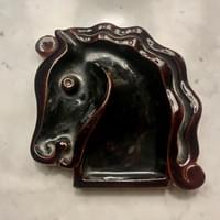Horse's head shaped ceramic vide- poche. Dark brown glaze This design is traditionally attributed to Jean Cocteau. Stamped " Hermès " Hermès circa 1945,15 cm x 16 cm x 3cm