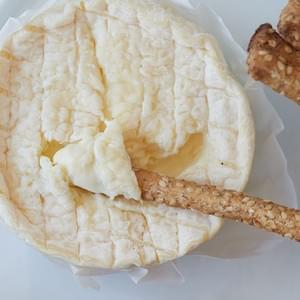 Dipping a Seasalt Sesame Z Breadstick into brie