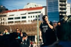 ActionStation staff member and event co-organiser Kassie addresses the crowd at an Ihumaatao solidarity action ActionStation staff member and event co-organiser Kassie addresses the crowd at an Ihumaatao solidarity action