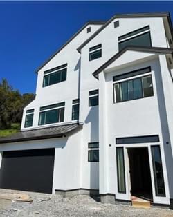 FINAL PLASTER COAT IN CONSTRUCTION OF A 2,760 SQUARE FOOT, THREE-STORY RESIDENCE