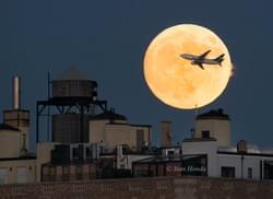 Airplane Crosses the 'Supermoon' Over NYC Airplane Crosses the 'Supermoon' Over NYC