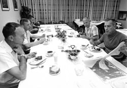 The Apollo 11 crew and Donald K. "Deke" Slayton look over charts during the traditional launch day breakfast of steak and eggs on July 16, 1969. (NASA)
