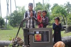 The Chhor Noam family of Cambodia, depicted with their two kids (aged 2 & 8) in front of the water well donated by MTRF The Chhor Noam family of Cambodia, depicted with their two kids (aged 2 & 8) in front of the water well donated by MTRF