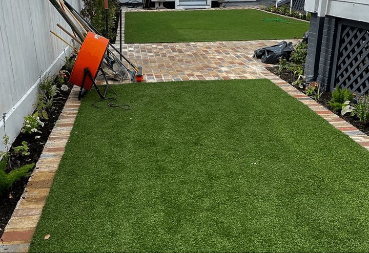 Backyard artificial turf grass with brick walkway and border installed in Galveston Backyard artificial turf grass with brick walkway and border installed in Galveston