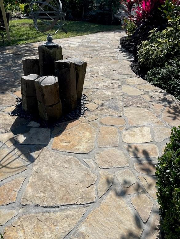 Custom flagstone patio walkway with water feature installed in Galveston Custom flagstone patio walkway with water feature installed in Galveston