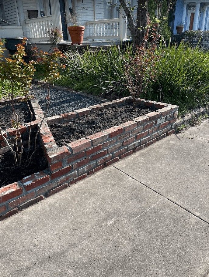 Custom brick flower beds with gravel walkway installed in Galveston Custom brick flower beds with gravel walkway installed in Galveston