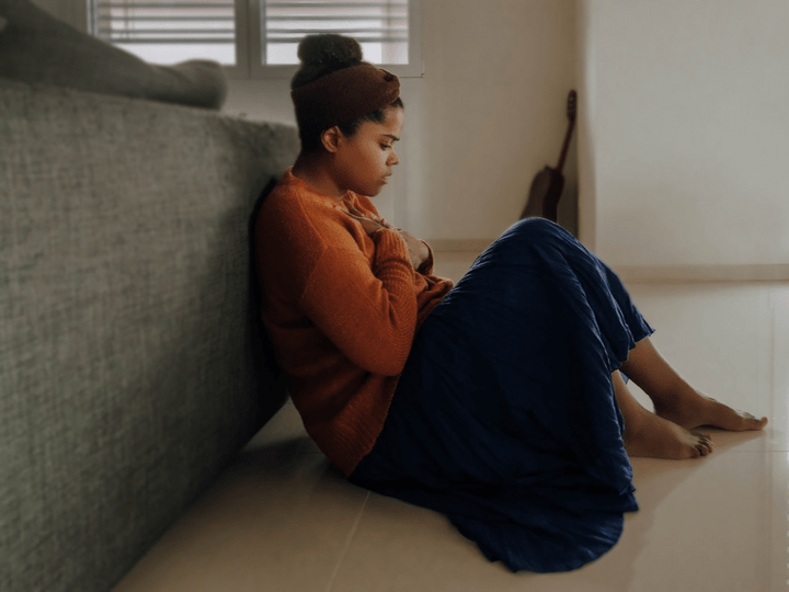 Picture of Person sitting on floor hugging self Picture of Person sitting on floor hugging self