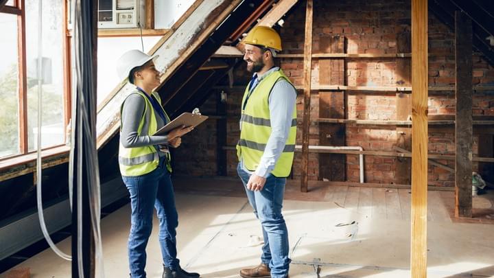 A female DDA Access Consultant. standing looking at her tablet PC while inspecting a building A female DDA Access Consultant. standing looking at her tablet PC while inspecting a building