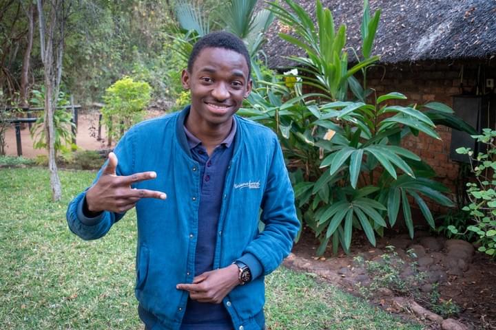 Nekacheya Travel and Tours  guide Herbert   with Zebras in the background  Nekacheya Travel and Tours  guide Herbert   with Zebras in the background