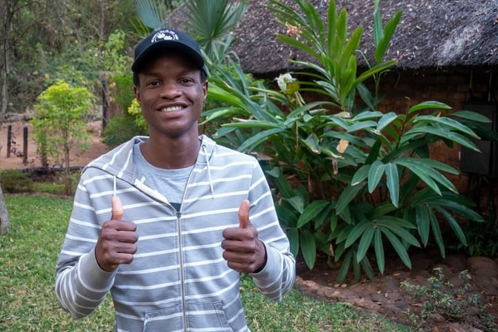 Nekacheya Travel and Tours, activity consultant Innocent having a good time in the Chobe National Park in Botswana. African Safari with an Elephant in the background Nekacheya Travel and Tours, activity consultant Innocent having a good time in the Chobe National Park in Botswana. African Safari with an Elephant in the background