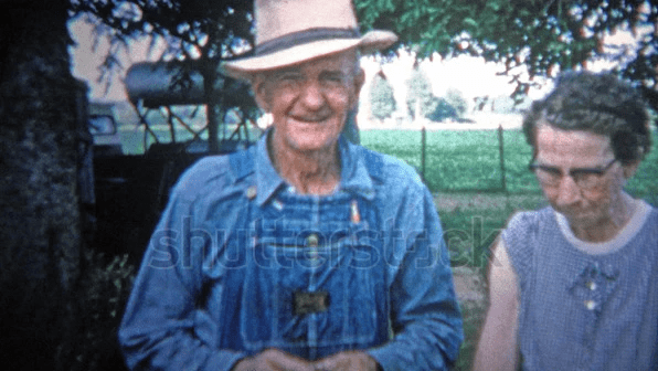 A retro clip of an old farmer with his wife in front of family farm. A retro clip of an old farmer with his wife in front of family farm.