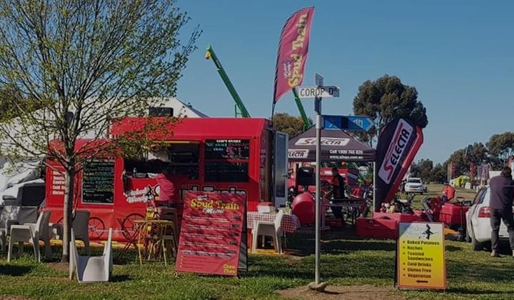 A picture of Wicked Wendy's Spud Train Food Truck on a Park. A picture of Wicked Wendy's Spud Train Food Truck on a Park.