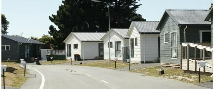 An image of newly built houses along a suburban road An image of newly built houses along a suburban road