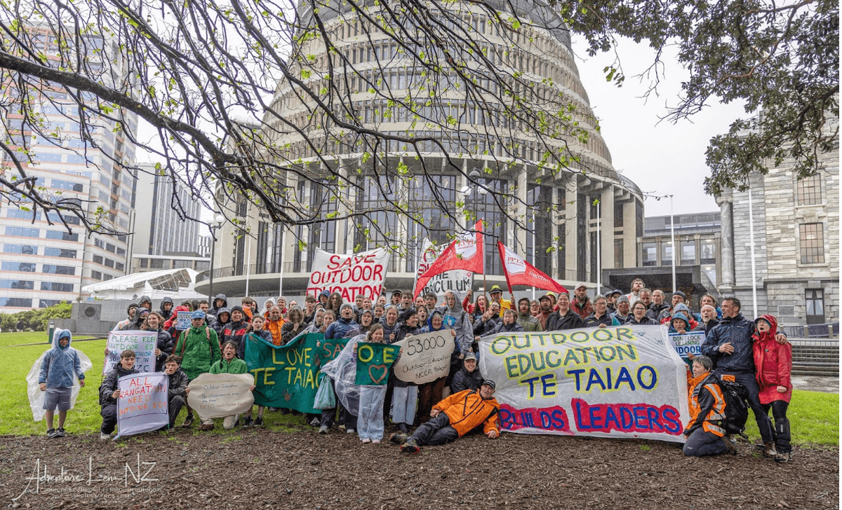 People with colourfull banners outside Parliament at the save outdoor education petition delivery People with colourfull banners outside Parliament at the save outdoor education petition delivery