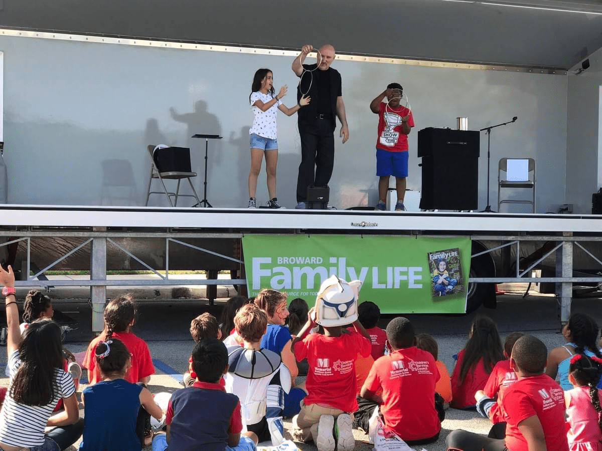 South Florida Magician Brent Gregory performing on stage at Broward festival South Florida Magician Brent Gregory performing on stage at Broward festival