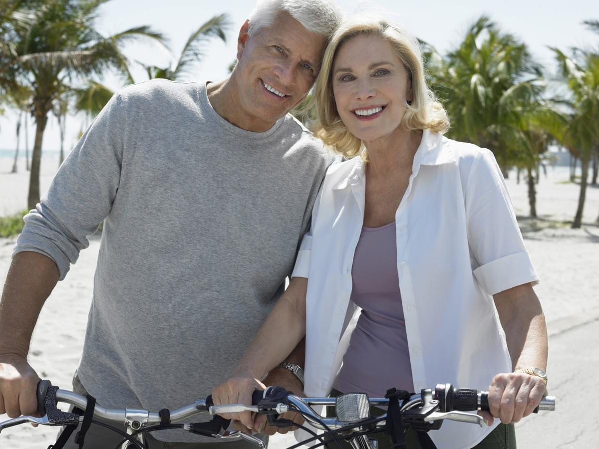 Happy Middle Aged Couple on Bikes  Happy Middle Aged Couple on Bikes
