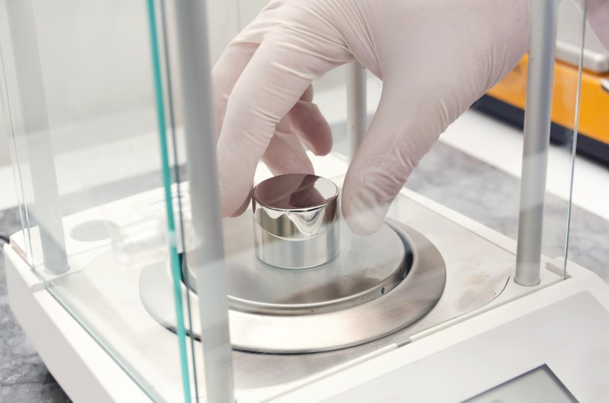 Gloved Hand Placing Calibrated Silver Weight on High Tech Scale used in a Compounding Pharmacy Gloved Hand Placing Calibrated Silver Weight on High Tech Scale used in a Compounding Pharmacy