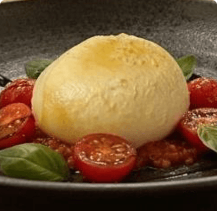 Naturally smoked mozzarella served with tomatoes and basil. Naturally smoked mozzarella served with tomatoes and basil.
