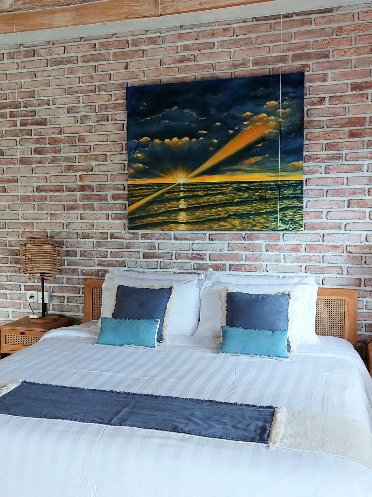 Wood room 4 - bed with blue gold sunset painting at Spaces Bali Wood room 4 - bed with blue gold sunset painting at Spaces Bali