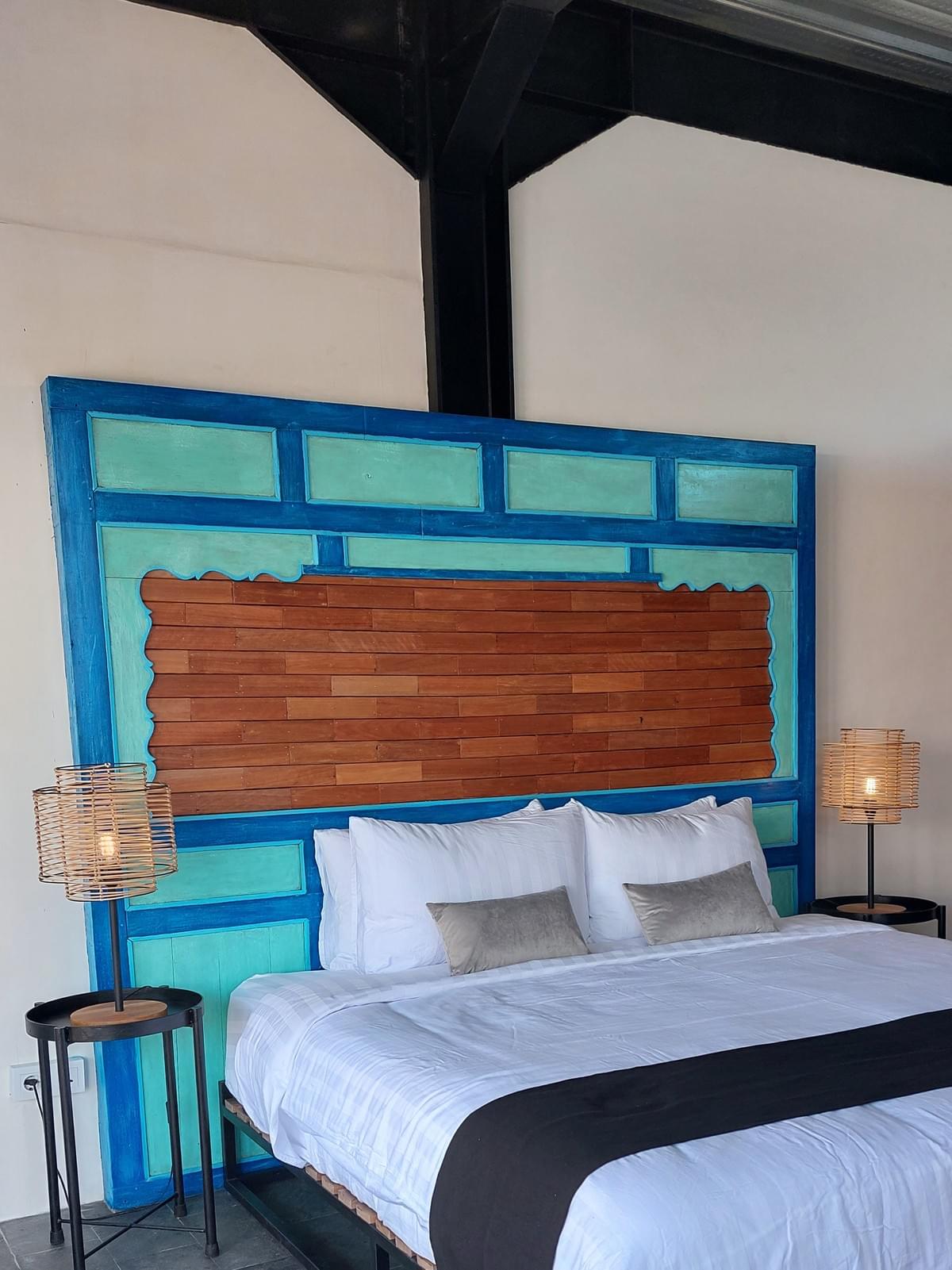 Stone room - bed with blue bedhead at Spaces Bali Stone room - bed with blue bedhead at Spaces Bali