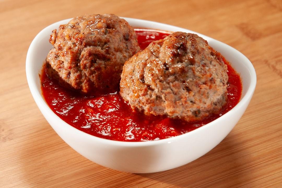 bowl of two meatballs in marinara sauce bowl of two meatballs in marinara sauce