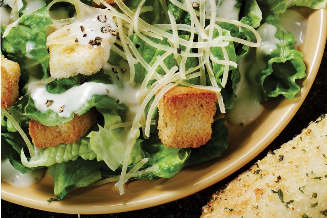 bowl of caesar salad with croutons bowl of caesar salad with croutons