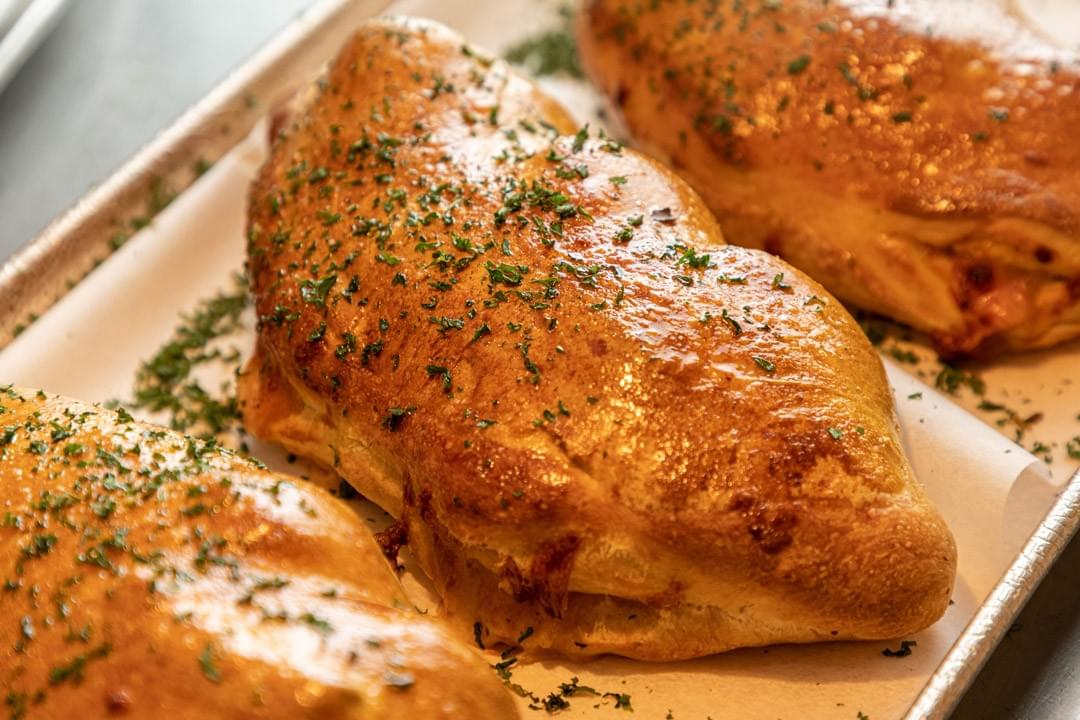 photo of baked calzones photo of baked calzones