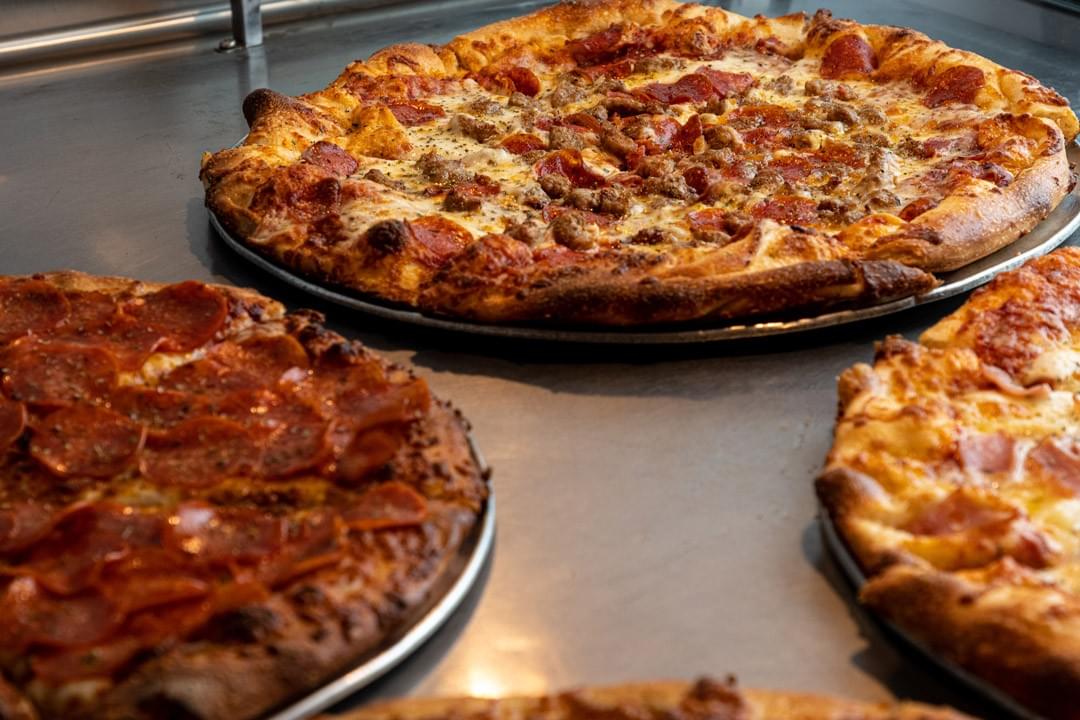 picture of a variety of whole pizzas picture of a variety of whole pizzas