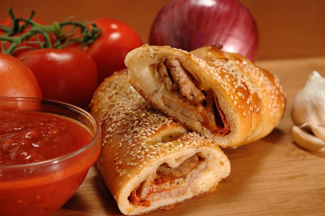 picture of pepperoni and sausage stromboli with fresh vegetables picture of pepperoni and sausage stromboli with fresh vegetables