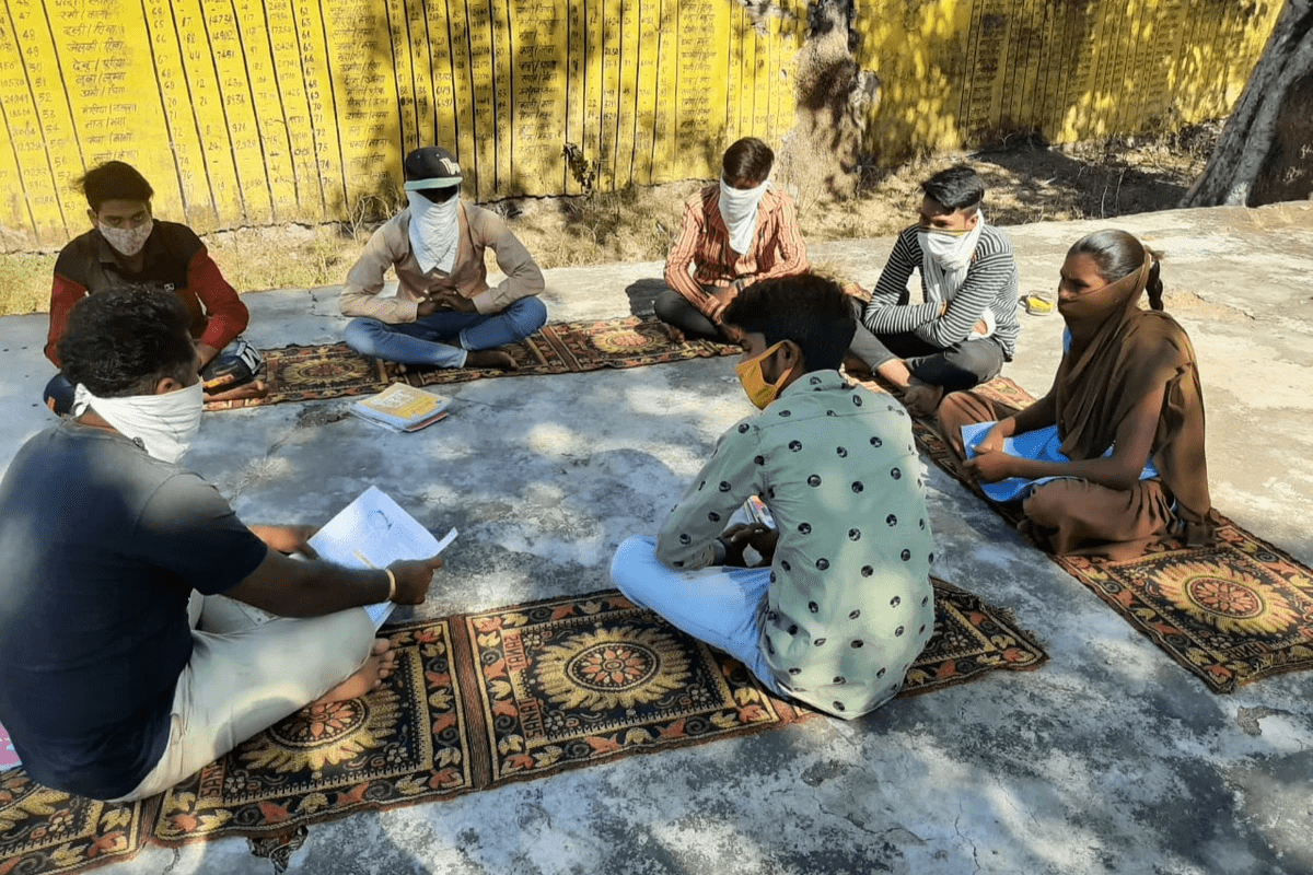 Secondary school students sitting in a learning circle outdoors. Secondary school students sitting in a learning circle outdoors.