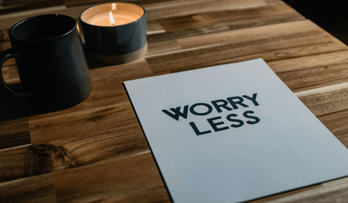 A table with two candles and a paper with the writing worry less representing stress and anxiety support with coping strategies from an online therapist. A table with two candles and a paper with the writing worry less representing stress and anxiety support with coping strategies from an online therapist.