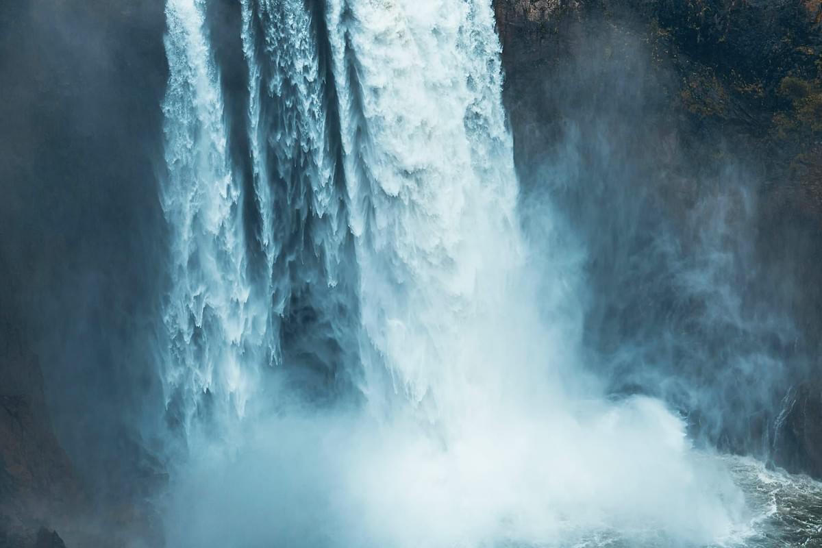 bottom of a crashing waterfall with mist rising up bottom of a crashing waterfall with mist rising up