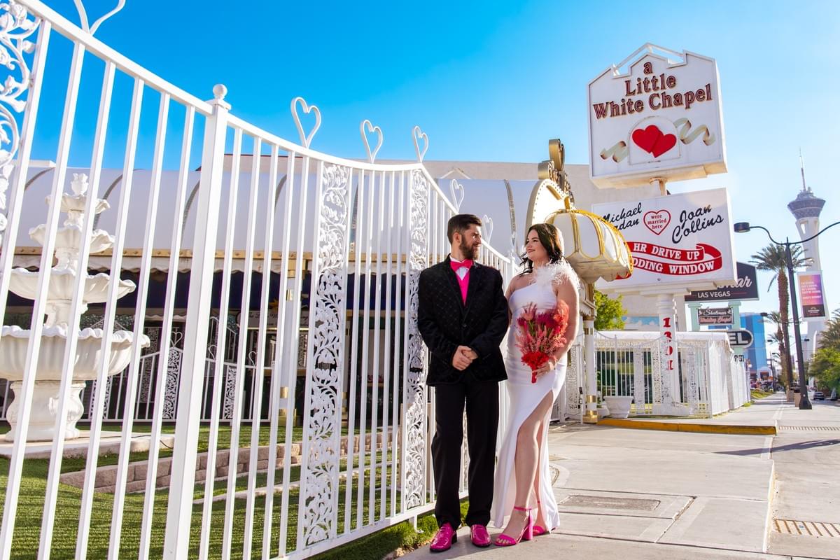 Newlyweds posing in front of the Little White Wedding Chapel in Las Vegas Newlyweds posing in front of the Little White Wedding Chapel in Las Vegas