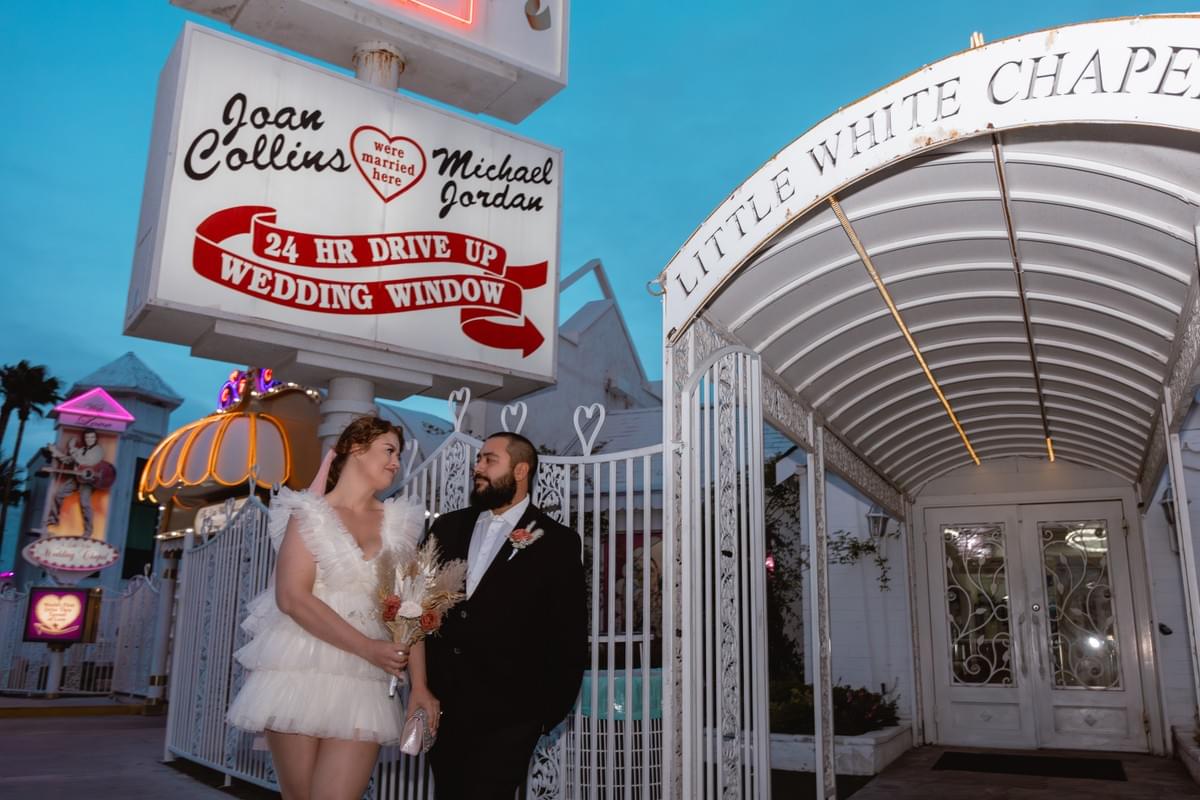 Couple standing outside the Little White Wedding Chapel in Las Vegas, ready for their elopement. Couple standing outside the Little White Wedding Chapel in Las Vegas, ready for their elopement.